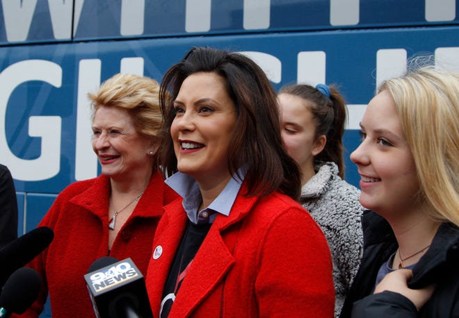 Michigan Democratic gubernatorial candidate Gretchen Whitmer answers questions with Sen. Debbie Stabenow, D-Lansing, left, and daughters Sherry, rear, and Sydney, right, after casting her ballot, Tuesday, Nov. 6, 2018, at St. Paul Lutheran Church in East Lansing.