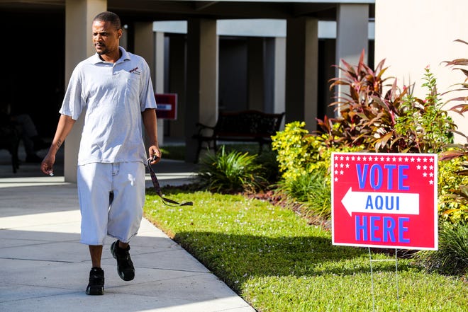 Voters head in and out of Precinct 9 sign in Fort Myers as they exercise their right to vote. 