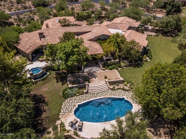 This Paradise Valley mansion in the Mummy Mountain Park community has Berghoff landscaping, a pool, spa and multiple patios.