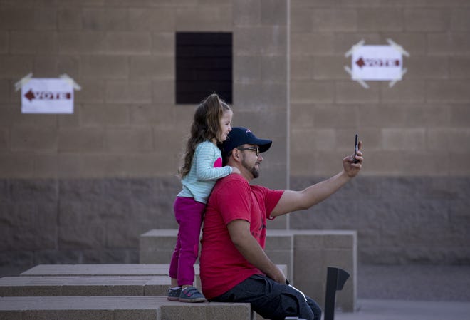 Michael Abril takes a selfie with his daughter, Hazel Abril, 3, before they go in for him to vote, Nov. 6, 2018, Glendale Elementary School District, 7301 N. 58th Ave. in Glendale.