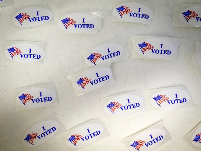 "I Voted" stickers cover a table.