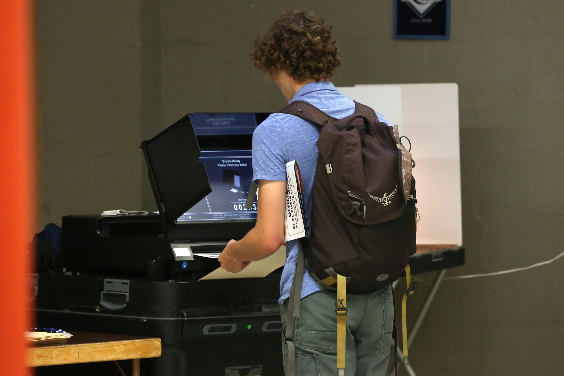 A voter casts his ballot at the Lafayette Community Center for the midterm elections on Election Day, Nov. 6, 2018.