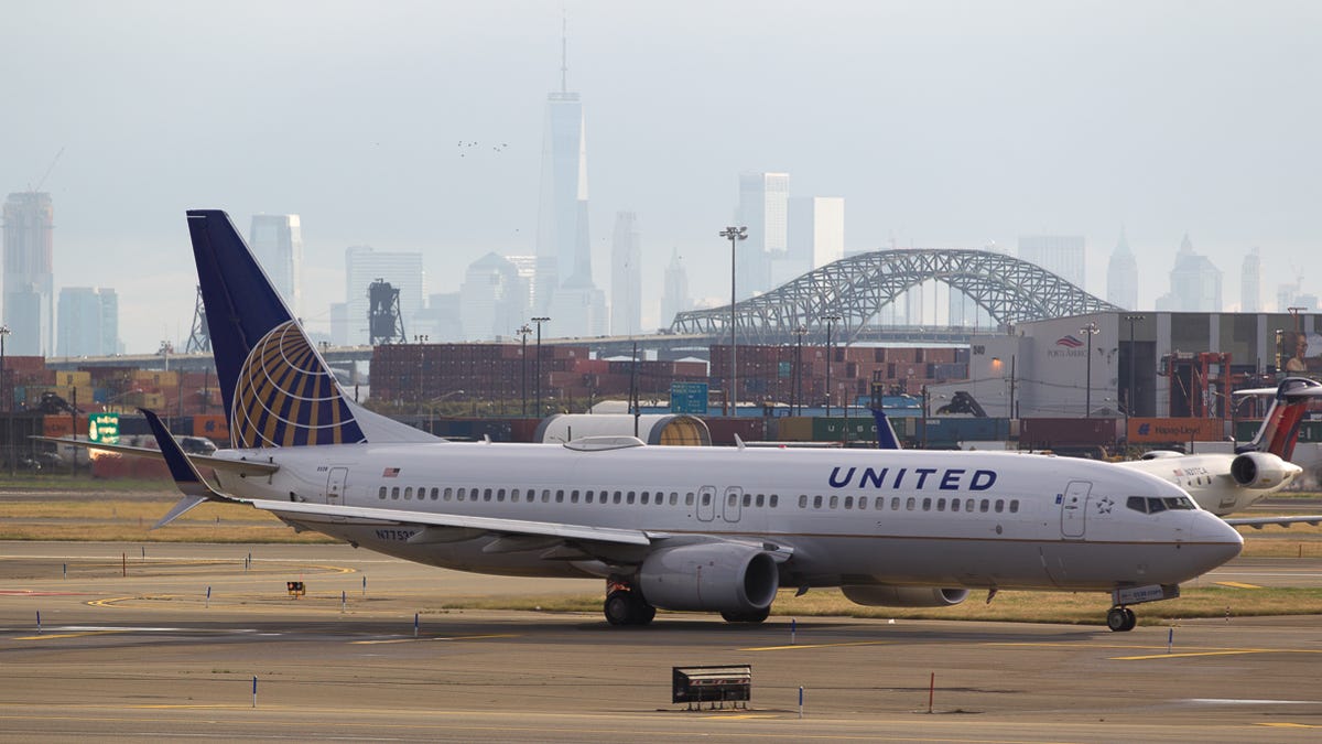 The New York City skyline provides a dramatic backdrop as a United Airlines Boeing 737-800 taxies to the gate after landing at Newark Liberty International Airport in October 2018.