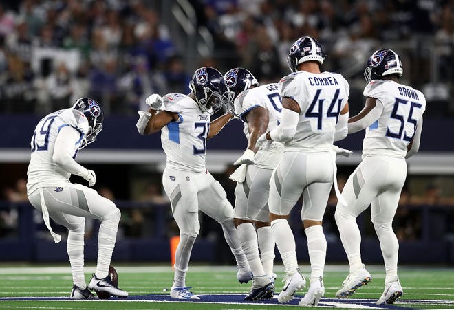 Tennessee Titans players celebrate a first quarter interception by Kevin Byard #31 against the Dallas Cowboys on the Star at the middle of the field at AT&T Stadium on November 5, 2018 in Arlington, Texas.