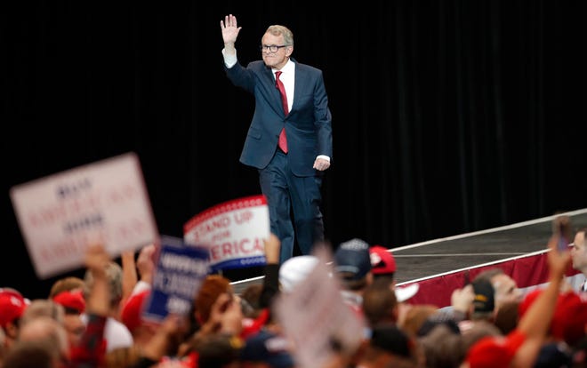 Republican gubernatorial candidate Mike DeWine waves to supporters as he walks to the podium at a campaign rally, Monday, Nov. 5, 2018, in Cleveland. (AP Photo/Tony Dejak)