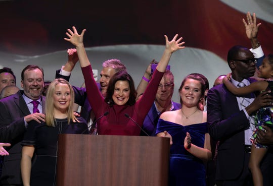 Michigan Governor elect Gretchen Whitmer, flanked by her two daughters, celebrates her victory during the watch party held at the Sound Board in the MotorCity Casino in Detroit Tuesday, Nov. 6, 2018.