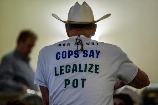 Retired Bath Township Police Det. Howard "Cowboy" Wooldrige waits for election results to come in for Proposal 1 in Lansing on Tuesday.