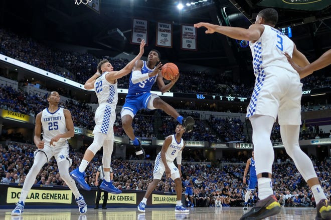 Duke forward RJ Barrett (5) shoots around Kentucky forward Reid Travis (22) during the first half of an NCAA college basketball game at the Champions Classic in Indianapolis Tuesday, Nov. 6, 2018.