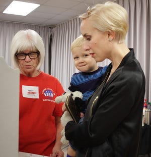 Whitney Hanes and Gage (2) get voting instruction from Mary Costello at Volunteer State Community College in Gallatin, TN on Tuesday, November 6, 2018. 