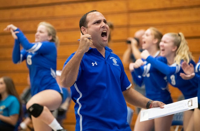 Barron Collier head coach Yamil Del Valle celebrates a point during the Class 7A regional final match against Port Charlotte at Barron Collier High on Tuesday.
