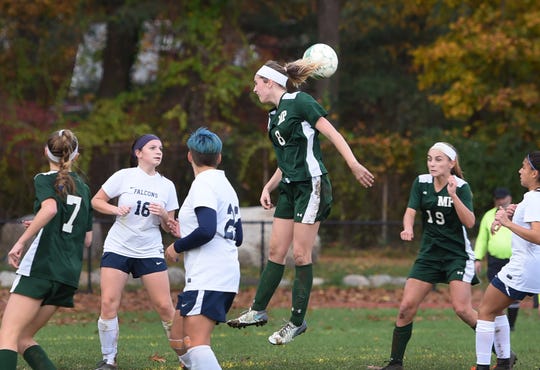 Avery O'Dell (no. 8) of Midland Park (in green) heads the ball during the North 1, Group 1 girls soccer semifinal at Midland Park High School on 11/07/18. Midland Park won the game 6 to 1. 