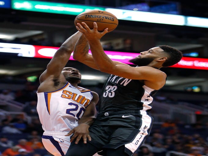 Brooklyn Nets guard Allen Crabbe (33) drives on Phoenix Suns forward Josh Jackson during the first half during an NBA basketball game Tuesday, Nov. 6, 2018, in Phoenix. (AP Photo/Rick Scuteri)