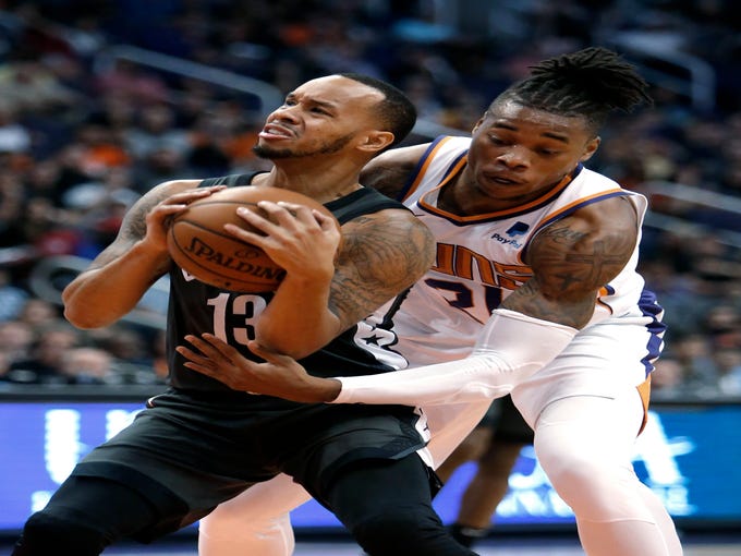 Brooklyn Nets guard Shabazz Napier (13) gets pressured by Phoenix Suns forward Richaun Holmes during the first half of an NBA basketball game Tuesday, Nov. 6, 2018, in Phoenix. (AP Photo/Rick Scuteri)