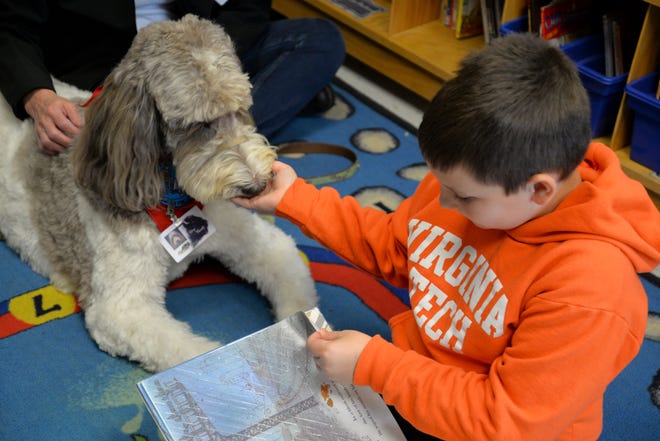 Kathleen Wilson and her labradoodle, Rory, visit Churchville Elementary once a week so students can read to the dog. Rory is a certified therapy dog and is allowed in any Augusta County School or school function. Here Rory is pictured with Mason Abshirine, 9 years old.