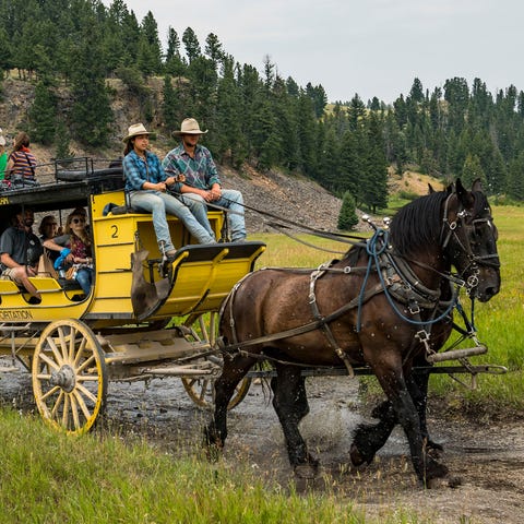 Horse-drawn, replica stagecoaches help give a...