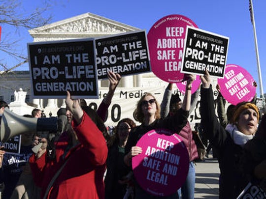 A crowd gathers outside the U.S. Supreme Court in January to defend and protest legalized abortion.
