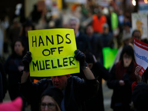Demonstrators complete a loop of downtown during a nationwide protest following the resignation of attorney general Jeff Sessions and President Donald Trump's appointment of Matthew Whitaker at Piatt Park in downtown Cincinnati on Thursday, Nov. 8, 2018.