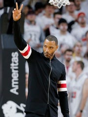 Kenyon Martin, the No. 1 pick in the 2000 NBA Draft, waves to fans during UC's game against Ohio State in November 2018.
