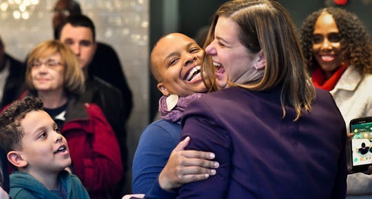 Michigan congresswoman-elect Elissa Slotkin embraces Tara Scott-Miller of Lansing, as son Kiran Miller, 8, looks on, Thursday, Nov. 8, 2018.  Slotkin met with constituents at Strange Matter Coffee Co. in downtown Lansing, and spoke about her immediate plans for her first term in office.