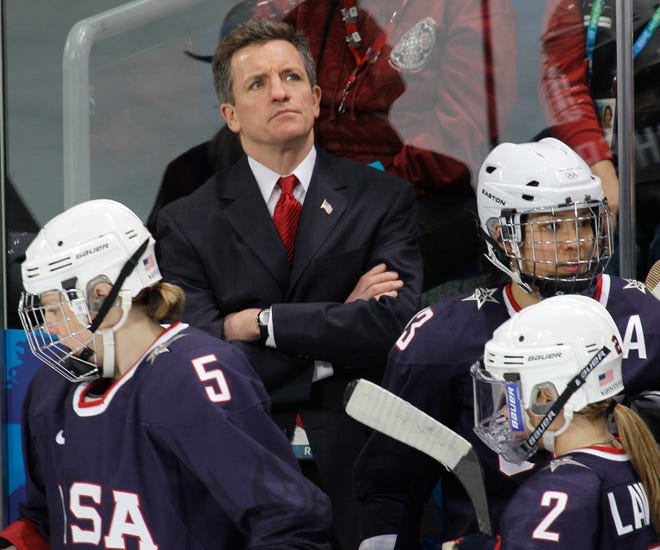 USA women's hockey head coach Mark Johnson watches his team play China in women's preliminary round hockey play at the Vancouver 2010 Olympics in Vancouver, British Columbia, Sunday, Feb. 14, 2010.