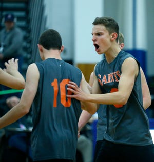 Class B volleyball final: Churchville-Chili's Greg Czolgosz reacts to teammate Truman Benz after scoring for a 20-11 lead in a second set they won against Midlakes at Webster Schroeder High School.