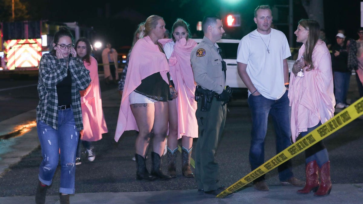 People comfort each other at the scene of a mass shooting at the Borderline Bar and Grill in Thousand Oaks, Calif., Nov. 8, 2018.