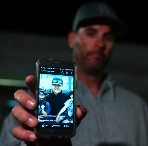 Jason Coffman displays a photo of his son Cody...