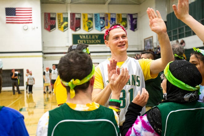 Iowa City West teacher John Henry Boylan (31) high-fives students during introductions before a basketball game on Thursday, Nov. 1, 2018, at West High School in Iowa City.