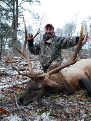 Dan Vandertie of Brussels, Wisconsin poses with the 6-by-6 bull elk he shot Nov. 8, 2018, the inaugural Wisconsin elk hunting season following the 1995 reintroduction of the native species.