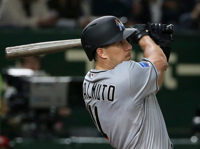 MLB All-Star catcher J.T. Realmuto of the Miami Marlins hits a solo home-run off Yomiuri Giants pitcher Ryusei Oe in the fifth inning of their exhibition baseball game at Tokyo Dome in Tokyo, Thursday, Nov. 8, 2018. (AP Photo/Toru Takahashi)
