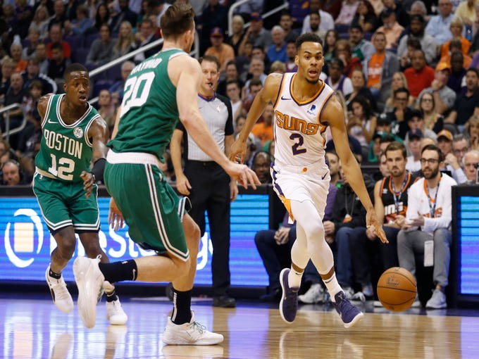 Suns' Elie Okobo (2) drives against the Celtics' Gordon Hayward (20) during the first half at Talking Stick Resort Arena in Phoenix, Ariz. on November 8, 2018. 