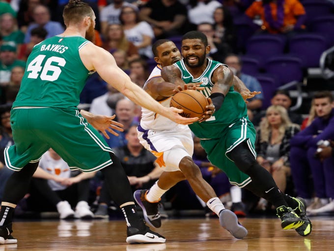 Suns' Trevor Ariza (3) tries to poke a ball free on a pass from Celtics' Aron Baynes (46) to Kyrie Irving (11) during the first half at Talking Stick Resort Arena in Phoenix, Ariz. on November 8, 2018.