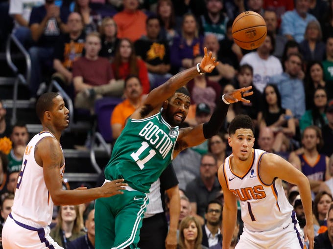 Suns' Trevor Ariza (3) defends Celtics' Kyrie Irving (11) during the first half at Talking Stick Resort Arena in Phoenix, Ariz. on November 8, 2018. 