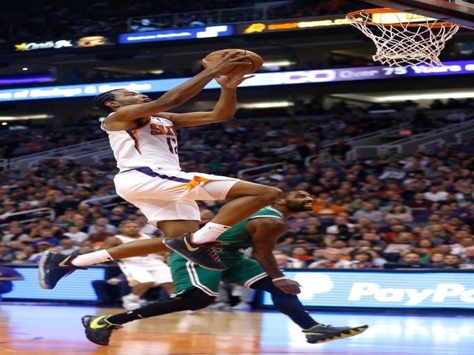 Suns' TJ Warren (12) makes a layup against the Celtics during the first half at Talking Stick Resort Arena in Phoenix, Ariz. on November 8, 2018.