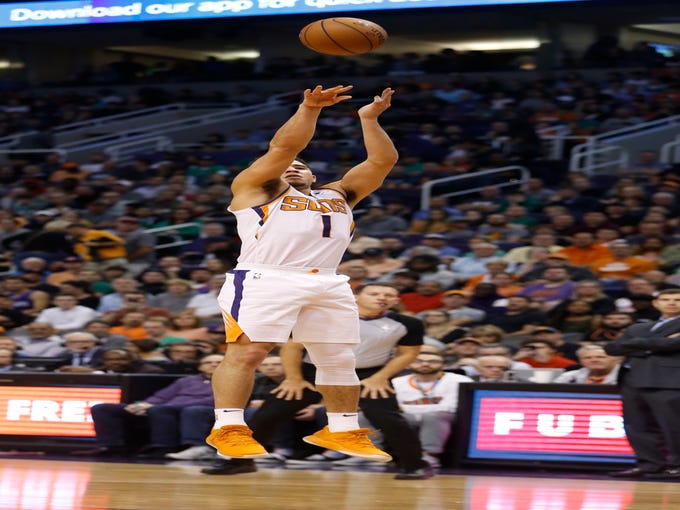 Suns' Devin Booker (1) makes a jumper against the Celtics during the first half at Talking Stick Resort Arena in Phoenix, Ariz. on November 8, 2018. 