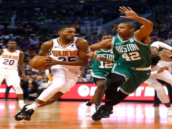 Suns' Mikal Bridges (25) drives against Celtics' Al Horford (42) during the first half at Talking Stick Resort Arena in Phoenix, Ariz. on November 8, 2018.
