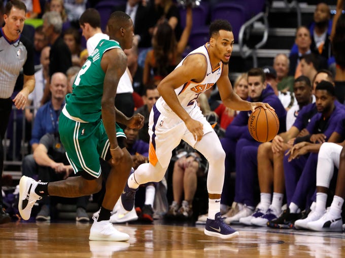 Suns' Elie Okobo (2) drives down court against Celtics' Terry Rozier III (12) during the first half at Talking Stick Resort Arena in Phoenix, Ariz. on November 8, 2018.