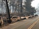 Abandoned and charred vehicles line a road in Paradise Friday after the Camp Fire destroyed the area on Thursday.