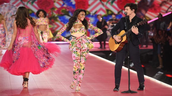 Winnie Harlow, center, walks the runway as Shawn Mendes performs during the 2018 Victoria's Secret Fashion Show.