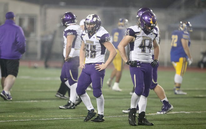 North Kitsap football players Cache Holmes (left) and Aidan Allsop react to the game clock reaching zero during Friday's Class 2A state tournament game against Fife at Sunset Chev Stadium in Sumner. North Kitsap lost 24-21.