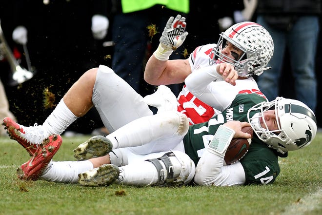 Michigan State's Brian Lewerke is sacked by Ohio State's Tuf Borland during the fourth quarter on Saturday, Nov. 10, 2018, in East Lansing.