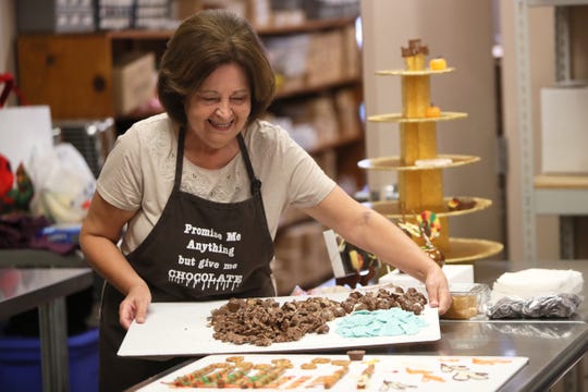 Kathy Faherty prepares a tray of assorted chocolates.