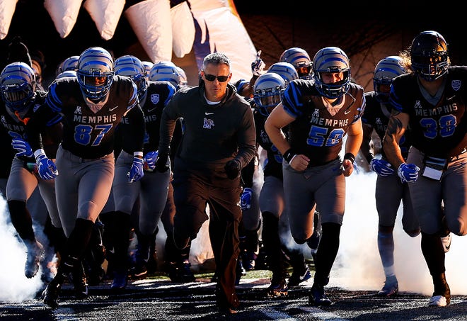 Memphis head coach Mike Norvell leads this players onto the field as they prepare to take on Tulsa in Memphis, Tenn., Saturday, November 10, 2018.