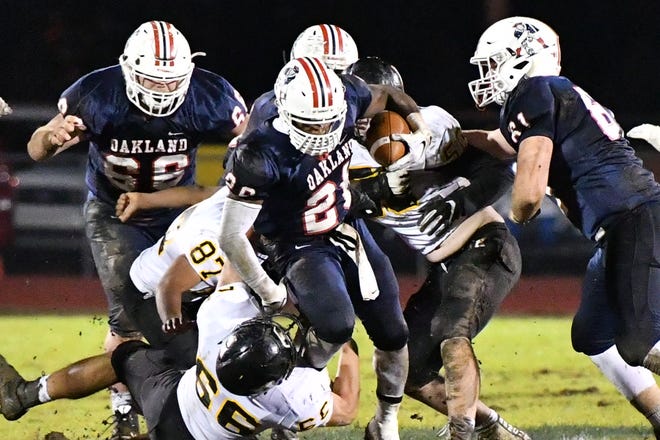 Oakland's Xavier Myers tries to break loose on a rush against Hendersonville Friday night.