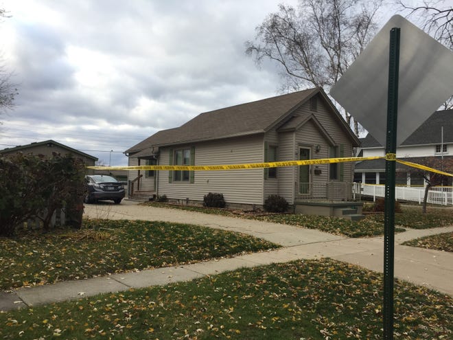 Evidence tape restricts access to a home on Stone Street in Port Huron where a mother and daughter were found dead.