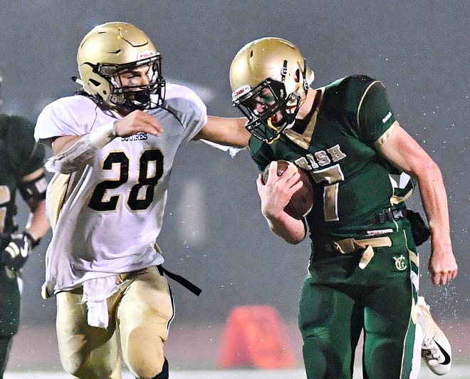 Mitchell Galentine, right, is seen here in action against Delone Catholic last season. Galentine is expected to be the Fighting Irish quarterback this season. The Irish are coming off a 12-1 season.