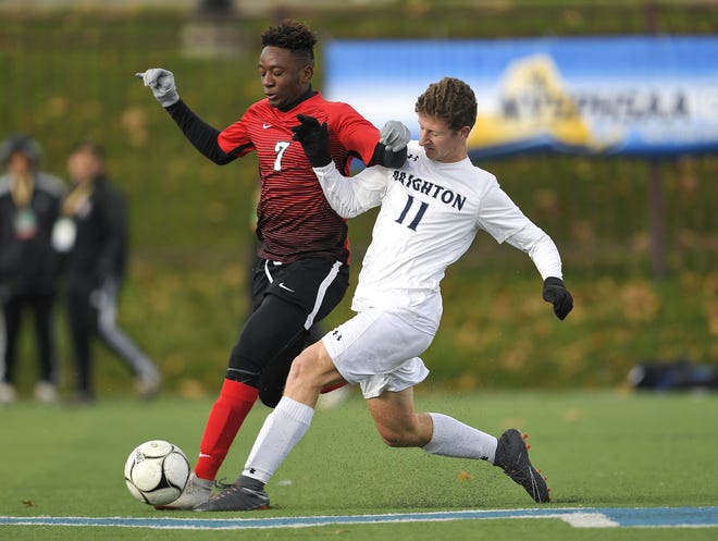 Brighton's Sam O'Connor, right, challenges for the ball against Amityville's Kymani Hines during a Class A semifinal at the NYSPHSAA Boys Soccer Championships in Newburgh, N.Y., Saturday, Nov. 10, 2018.