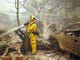 A firefighter pumps water on the smoldering remains of a residence in Paradise, California on Friday, Nov. 9, 2018.
