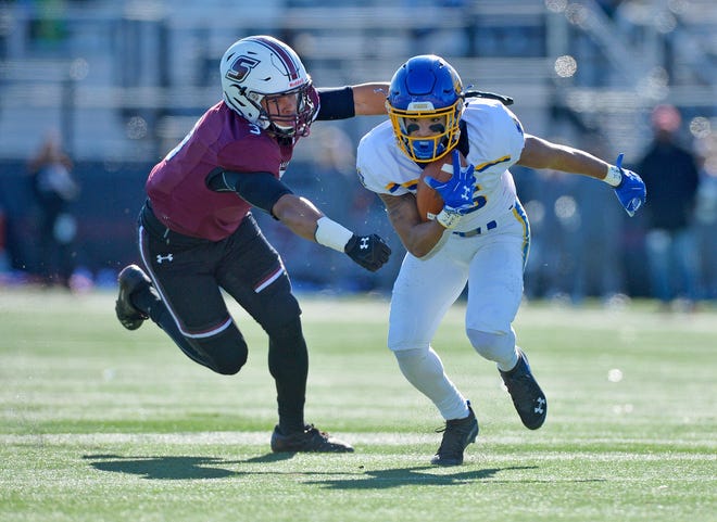 South Dakota State wide receiver Cade Johnson (15) avoids SIU linebacker Airan Reed (3) during the first half at Saluki Stadium on Saturday in Carbondale.