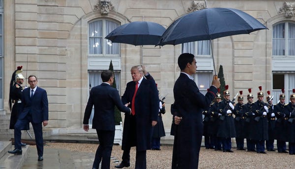 President Donald Trump is greeted by French...
